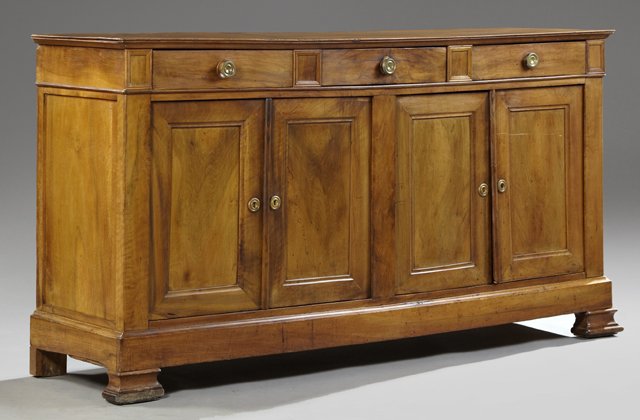 French Louis Philippe Carved Walnut Sideboard, 19th c.,: French Louis Philippe Carved Walnut Sideboard, 19th c., the rectangular top over three frieze drawers above four cupboard doors, to a plinth on stepped ogee feet, H.- 40 in., W.- 78 1/4 in., D.- 20 1/