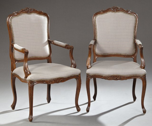 Pair of French Louis XV Style Carved Birch Fauteuils,: Pair of French Louis XV Style Carved Birch Fauteuils, 20th c., the serpentine floral carved crests over shield form backs, above bowed seats within reeded upholstered arms, on flower carved cabriole l