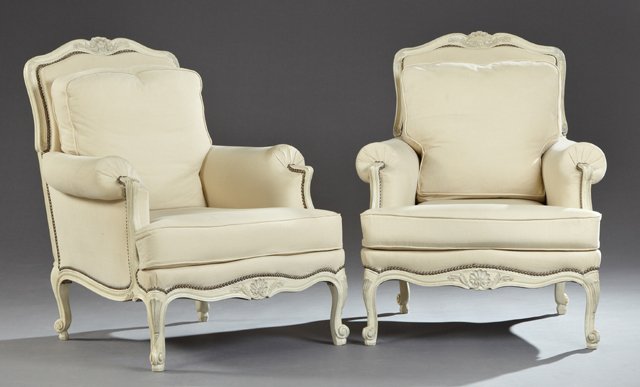 Pair of Louis XV Style Polychromed Bergeres, 20th c.,: Pair of Louis XV Style Polychromed Bergeres, 20th c., the arched serpentine shell carved crest over a cushion back above a T-seat cushion within rolled arms, on carved cabriole legs to scrolled feet, 
