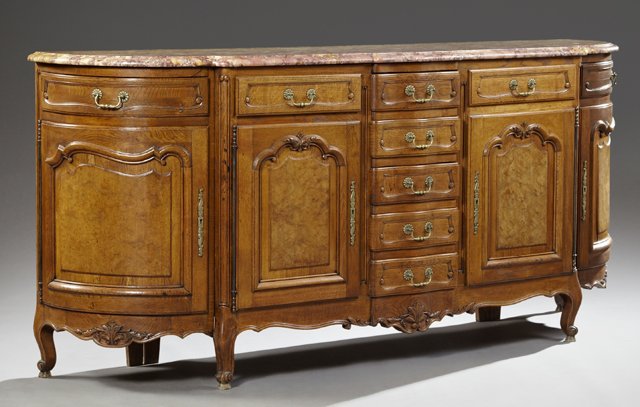French Louis XV Style Carved Oak Marble Top Sideboard,: French Louis XV Style Carved Oak Marble Top Sideboard, early 20th c., the breakfront demilune highly figured rouge and ochre marble, over a central bank of five drawers flanked on each side by a friez