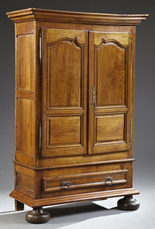 French Provincial Louis XIII Style Carved Cherry: French Provincial Louis XIII Style Carved Cherry Armoire, 19th c., the stepped crown over two fielded panel doors with a long iron escutcheon and short iron fiche hinges, on a base with a long drawer 
