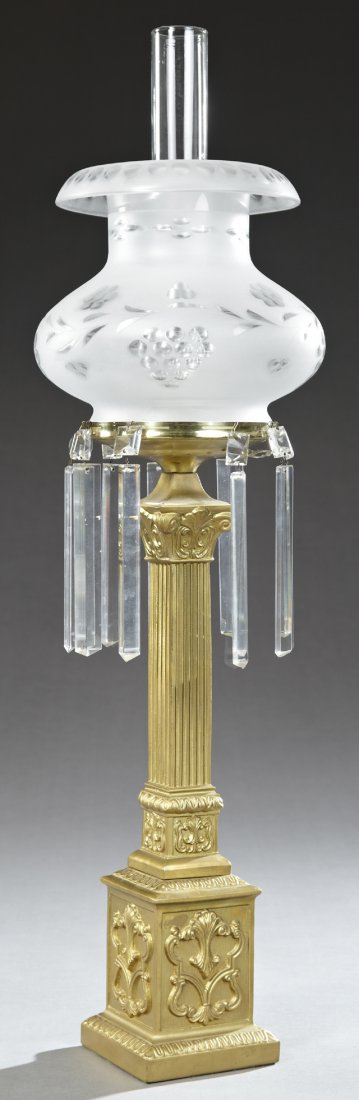 Gilt Sinumbra Lamp, 19th c. and later, the prism hung: Gilt Sinumbra Lamp, 19th c. and later, the prism hung shade ring, on a square Corinthian column support to a stepped relief decorated plinth on a square base, with a later etched and frosted glass sha