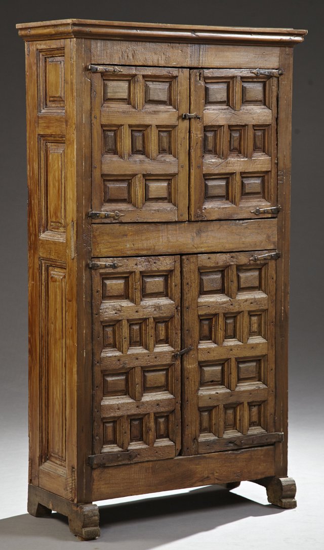 Spanish Colonial Style Carved Pine Cabinet, 19th c. and: Spanish Colonial Style Carved Pine Cabinet, 19th c. and later, the ogee stepped crown over two fielded panel cupboard doors with wrought iron hinges, above two like cupboard doors, flanked by fielded 