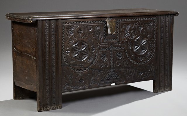 French Provincial Louis XIII Style Carved Walnut: French Provincial Louis XIII Style Carved Walnut Coffer, 19th c., the stepped rectangular top with an iron escutcheon and iron hinges over a geometric carved panel flanked by reeded carved stiles, on 