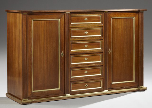 French Directoire Style Carved Mahogany Sideboard, earl: French Directoire Style Carved Mahogany Sideboard, early 20th c., the breakfront rectangular top over a bank of six brass trimmed central drawers with three faux drawers opening to a mirrored interior