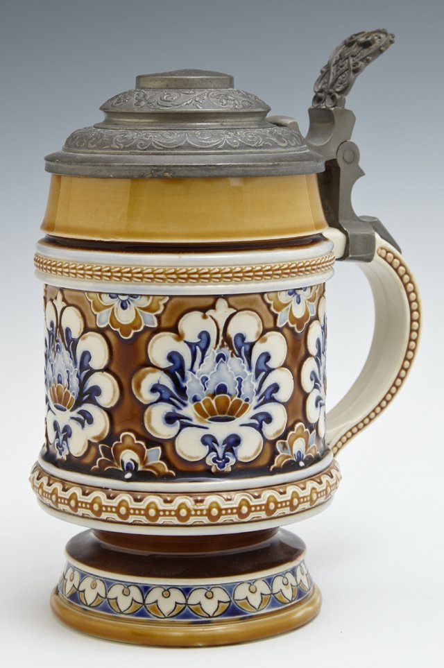 Mettlach Pewter Covered Stein, 19th c., #1190, by: Mettlach Pewter Covered Stein, 19th c., #1190, by Villeroy and Boch, with relief polychromed floral decoration, H.- 7 in., W.- 6 in., D.- 4 in.