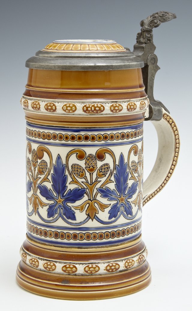 Mettlach Pewter Covered Stein, 19th c., #1155, by: Mettlach Pewter Covered Stein, 19th c., #1155, by Villeroy and Boch, with relief polychromed floral decoration, H.- 8 in., W.- 5 1/2 in., D.- 4 in.