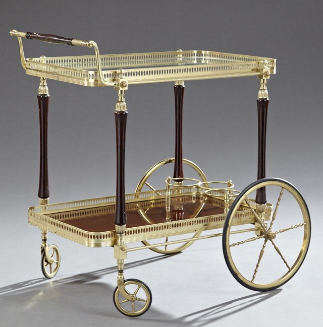 French Belle Epoque Style Carved Mahogany and Brass Tea: French Belle Epoque Style Carved Mahogany and Brass Tea Cart, 20th c., the turned handle over a pierced brass galleried glass top on turned tapered supports above a lower fitted brass galleried mahoga