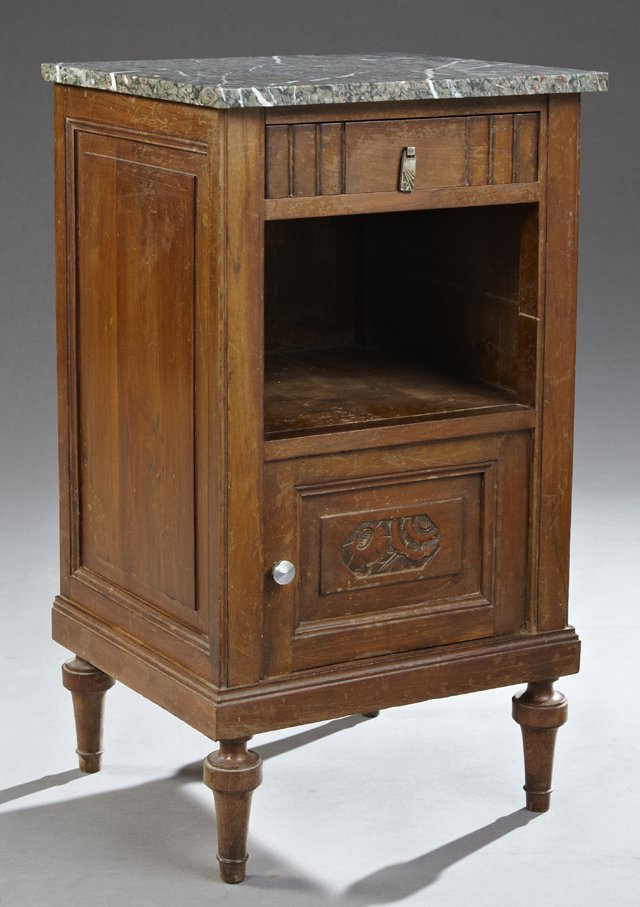 French Art Deco Carved Mahogany Marble Top Nightstand,: French Art Deco Carved Mahogany Marble Top Nightstand, early 20th c., the highly figured grey and pink marble over a carved frieze drawer, above an open shelf, over a cupboard door, to a plinth on rin