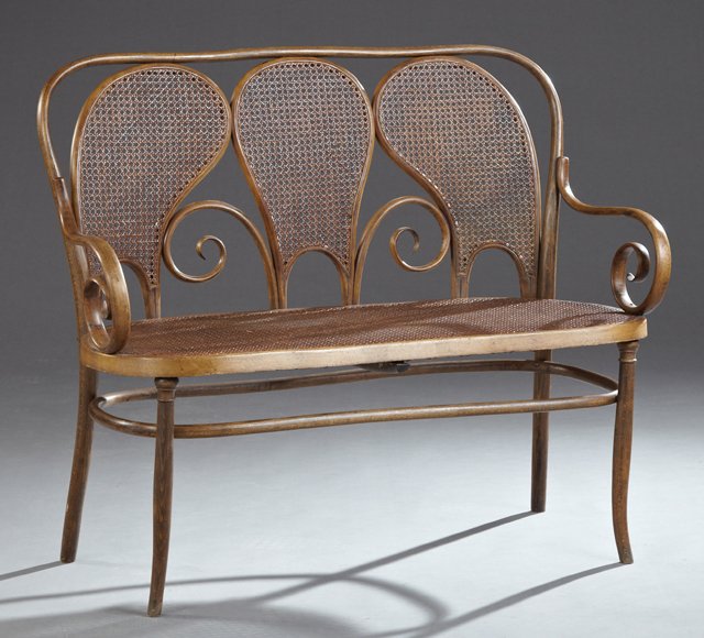 Late Victorian Bentwood Cane Seat Settee, late 19th c.,: Late Victorian Bentwood Cane Seat Settee, late 19th c., in the manner of Thonet, the serpentine triple cane paneled back with scrolled decoration over a kidney shaped cane seat within scrolled arms, o