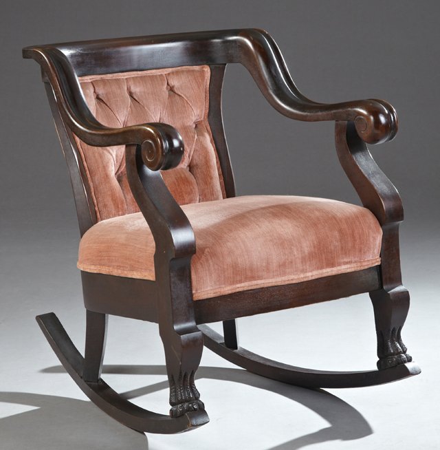 American Classical Revival Carved Mahogany Rocking: American Classical Revival Carved Mahogany Rocking Chair, c. 1910, the curved crest over a button tufted back above a bowed seat within scrolled arms on serpentine supports to carved paw feet, H.- 32 