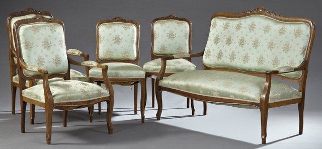 Five Piece French Louis XV Style Carved Walnut Salon: Five Piece French Louis XV Style Carved Walnut Salon Suite, early 20th c., consisting of two side chairs, two armchairs and a settee, with carved foliate crests over shield form backs over bowed seats