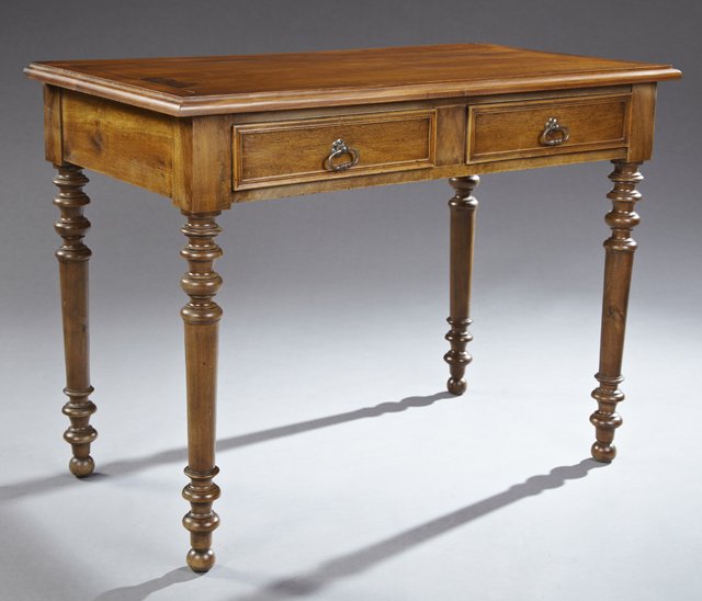 French Louis Philippe Carved Walnut Writing Table, 19th: French Louis Philippe Carved Walnut Writing Table, 19th c., the stepped rectangular top over a wide skirt with two frieze drawers, on ring turned tapered legs to ball feet, H.- 29 1/2 in., W.- 39 7/8