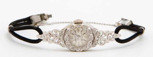 Lady's 14K White Gold Benrus Mechanist Wristwatch, mid: Lady's 14K White Gold Benrus Mechanist Wristwatch, mid 20th c., Model GM483, in a diamond mounted bezel with working leaf form lugs, on a black cord band, Wt.- .24 troy oz.