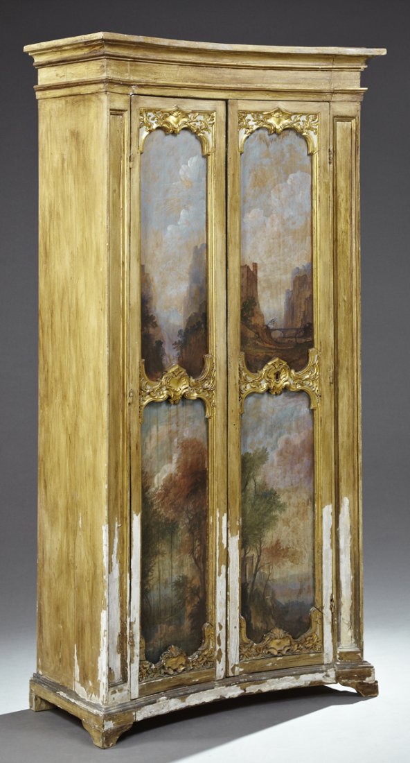 Italian Rococo Style Parcel Gilt, Gesso and Polychromed: Italian Rococo Style Parcel Gilt, Gesso and Polychromed Pine Armoire, early 19th c., the stepped ogee concave crown over two concave doors with inset oil on panel landscapes and carved gilt foliate de