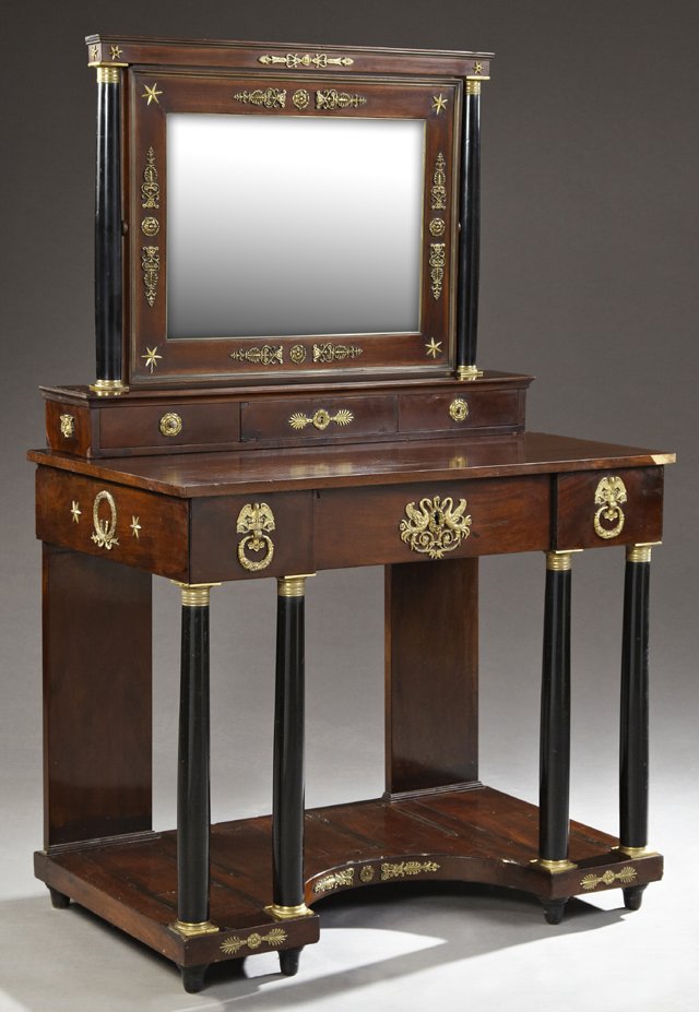 French Empire Style Ormolu Mounted Mahogany Dressing: French Empire Style Ormolu Mounted Mahogany Dressing Table, c. 1900, the framed mirror on ebonized columnar supports over three glove drawers, on a base with a central frieze drawer flanked by two sma