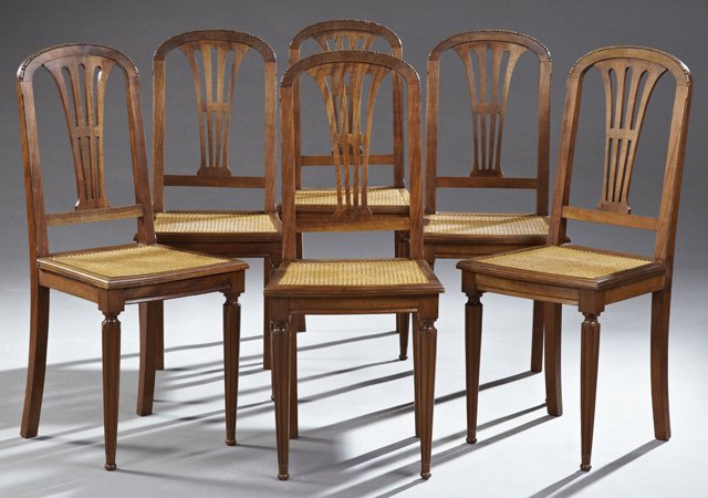 Set of Six Carved Oak Dining Chairs, early 20th c., the: Set of Six Carved Oak Dining Chairs, early 20th c., the arched carved crest rails over pierced back splats above square cane seats on ring turned tapered fluted legs to flat ball feet, H.- 37 in., W.-