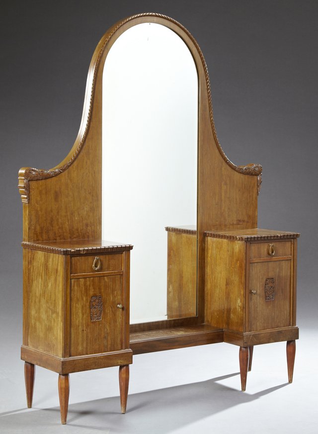 French Art Deco Carved Mahogany Dropwell Vanity, early: French Art Deco Carved Mahogany Dropwell Vanity, early 20th c., the arched mirror over an open shelf flanked by two drawers and two cupboard doors on tapered octagonal legs, H.- 66 in., W.- 51 1/2 in.