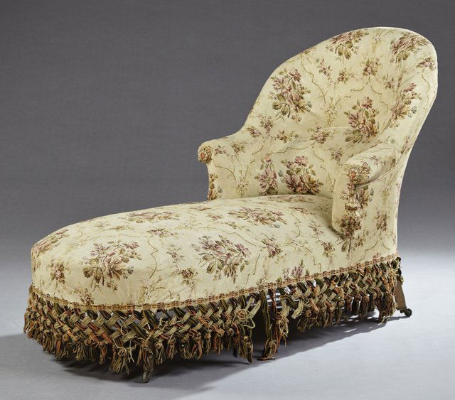 French Louis XVI Style Carved Beech Chaise Longue, c.: French Louis XVI Style Carved Beech Chaise Longue, c. 1870, the curved back to rolled arms over an oval seat, on ring turned tapered legs to casters, now in floral upholstery, H.- 36 in., W.- 25 in.,