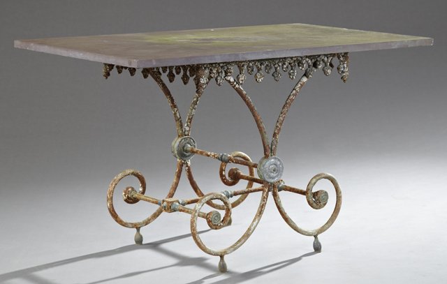 Diminutive French Cast Iron and Lead Baker's Table,: Diminutive French Cast Iron and Lead Baker's Table, 19th c., with a rectangular slate top, over a pierced foliate skirt on scrolled legs joined by stretchers, H.- 29 in., W.- 49 1/2 in., D.- 28 in.