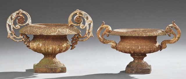 Near Pair of Italian Style Cast Iron Campana Form Urns,: Near Pair of Italian Style Cast Iron Campana Form Urns, 19th c., the floral decorated edges flanked by scrolling foliate handles on lobed tapered bases to square plinths, Largest- H.- 12 in., Dia.- 16