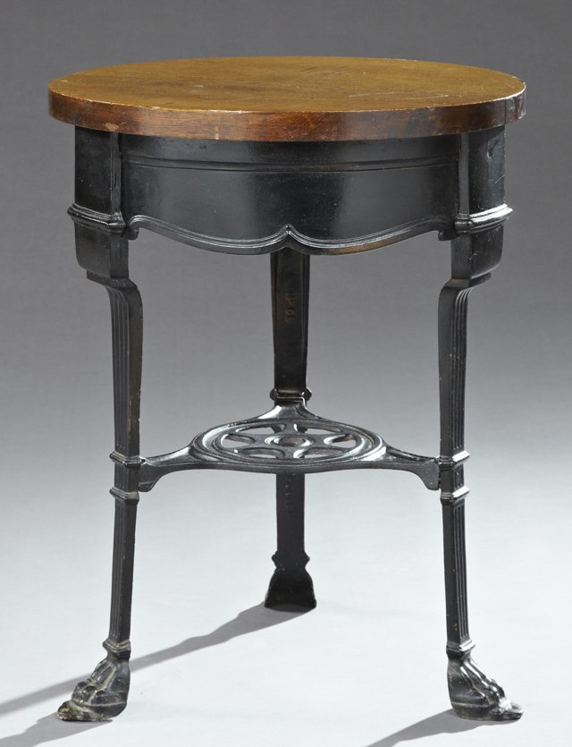 Victorian English Carved Oak Cast Iron Pub Table, late: Victorian English Carved Oak Cast Iron Pub Table, late 19th c., the circular oak top over a wide serpentine skirt on fluted legs to paw feet joined by a stretcher shelf, marked No. 66, H.- 30 3/4 in.,