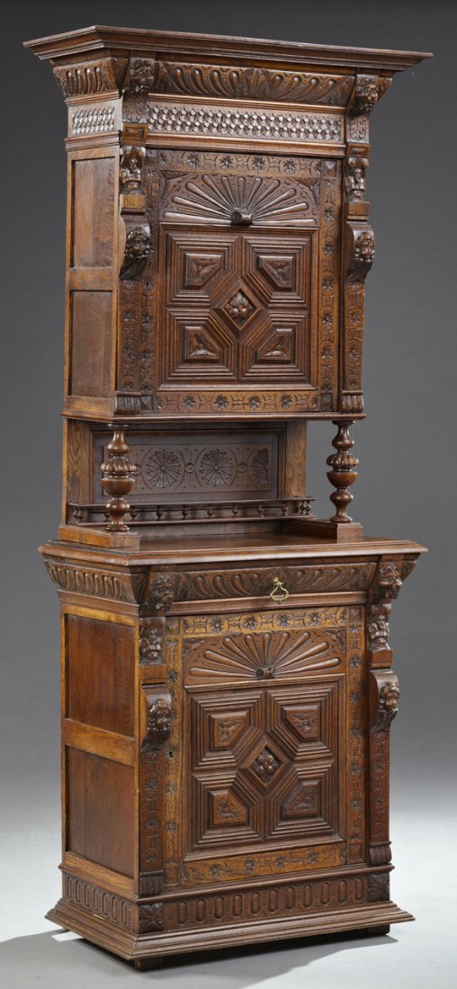 French Brittany Renaissance Style Carved Oak Buffet a: French Brittany Renaissance Style Carved Oak Buffet a Deux Corps, 19th c., the stepped ogee crown over a carved frieze flanked by lion masks, above a carved cupboard door flanked by figural and floral