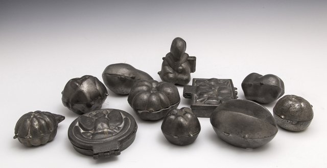 Group of Eleven Pewter Chocolate Molds, early 20th c.,: Group of Eleven Pewter Chocolate Molds, early 20th c., of varying shapes and objects, including fruits, playing cards, and an oriental figure. (11 Pcs.)