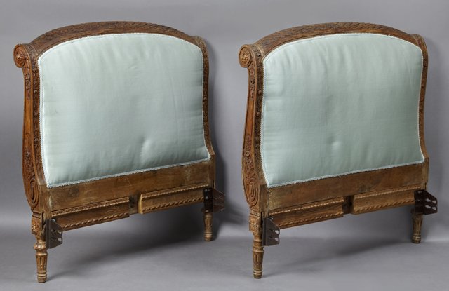 French Louis XVI Style Carved Oak Day Bed, 19th c., the: French Louis XVI Style Carved Oak Day Bed, 19th c., the arched leaf carved head and footboards within scrolled flower carved stiles to ring turned tapered stop fluted carved legs, now in blue upholste