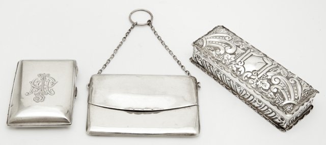 Three English Sterling Objects, consisting of a: Three English Sterling Objects, consisting of a cigarette case, Birmingham, 1924, by George Nathan and Ridley Hayes; a dresser box, Sheffield, 1897, with repousse decoration, by William Needham; and a