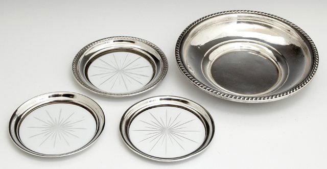 Four Pieces of Sterling, early 20th c., consisting of: Four Pieces of Sterling, early 20th c., consisting of three crystal sterling rim wine bottle coasters, and a circular gadroon rim stepped bowl by Watrous Mfg Co., Bowl Wt.- 5 troy oz., H.- 1 1/2 in.,