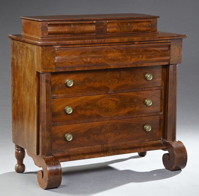 American Classical Carved Mahogany Chest, 19th c., with: American Classical Carved Mahogany Chest, 19th c., with two glove drawers atop a base with a rounded frieze drawer above three setback graduated drawers with brass repousse pulls, flanked by full octa