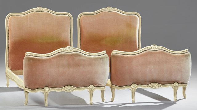 Pair of Louis XVI Style Polychromed Beds, 20th c., the: Pair of Louis XVI Style Polychromed Beds, 20th c., the serpentine head and sleigh form foot boards with central floral and leaf carved crest rails, over rose velvet upholstered panels, H.- 45 1/2 in.,
