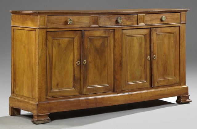 French Louis Philippe Carved Walnut Sideboard, 19th c.,: French Louis Philippe Carved Walnut Sideboard, 19th c., the rectangular top over three frieze drawers above four cupboard doors, to a plinth on stepped ogee feet, H.- 40 in., W.- 78 1/4 in., D.- 20 1/