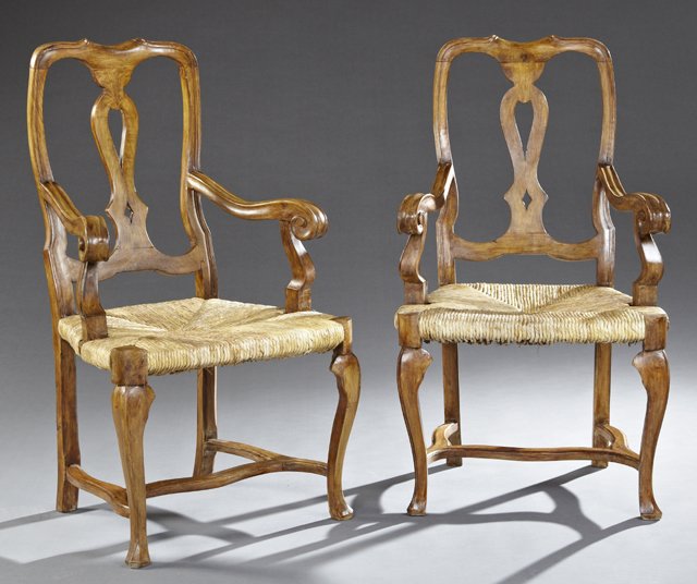 Pair of Continental Carved Beech Armchairs, 20th c., in: Pair of Continental Carved Beech Armchairs, 20th c., in the English style, with pierced back splats and scrolled arms, on reeded cabriole legs to triangular trifid feet, joined by a serpentine H-form