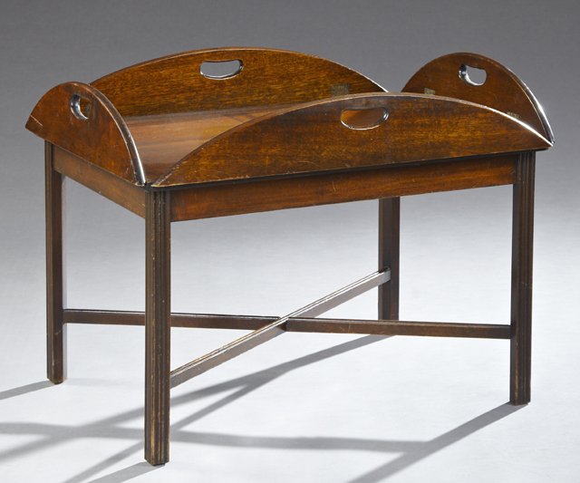 Carved Mahogany Butler's Tray Coffee Table, 20th c., on: Carved Mahogany Butler's Tray Coffee Table, 20th c., on reeded legs joined by an X-form stretcher, H.- 18 3/8 in., W.- 39 in., D.- 30 1/4 in.