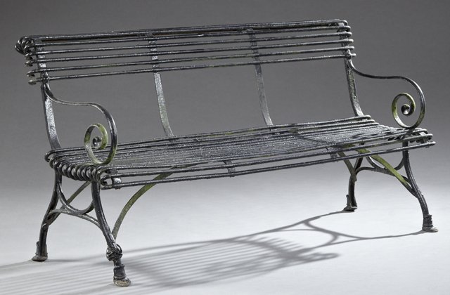 English Wrought Iron Garden Bench, early 20th c., with: English Wrought Iron Garden Bench, early 20th c., with iron bar back and seat and scrolled arms, on trestle legs on hoof feet, H.- 32 1/2 in., W.- 63 in., D.- 24 in.