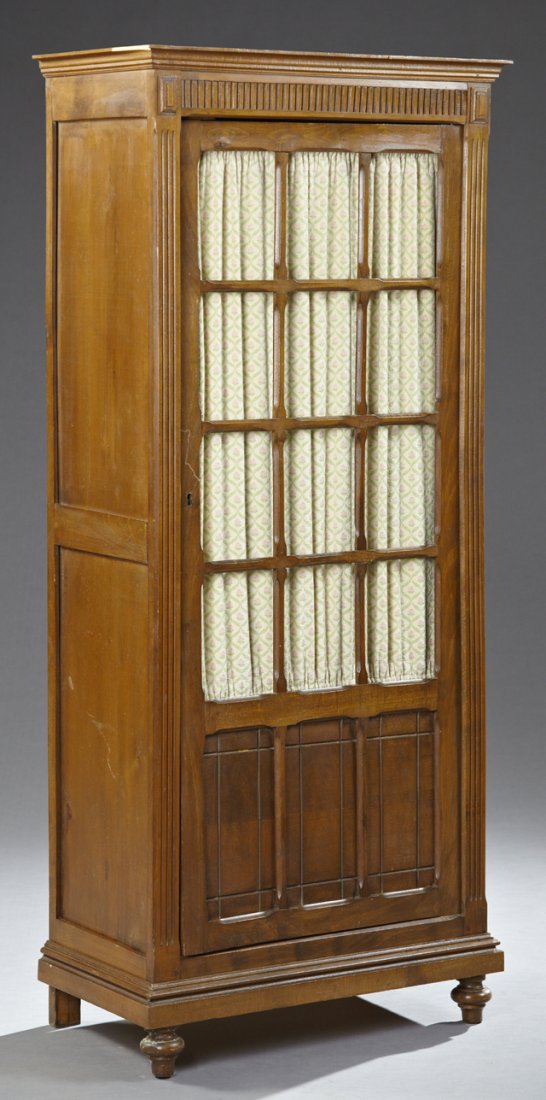 Diminutive Carved Birch Bookcase, early 20th c., the: Diminutive Carved Birch Bookcase, early 20th c., the ogee crown over a reeded frieze above a mullioned door over incised lower panels, flanked by reeded stiles, to a stepped plinth base on turned bun