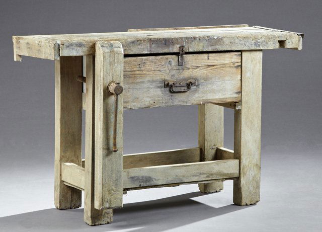 French Carved Pine Cabinet Maker's Workbench, 19th c.,: French Carved Pine Cabinet Maker's Workbench, 19th c., the thick top over a central deep drawer, flanked on one side by a wood vise, on thick block legs with a lower shelf, H.- 31 1/4 in., W.- 50 in.,