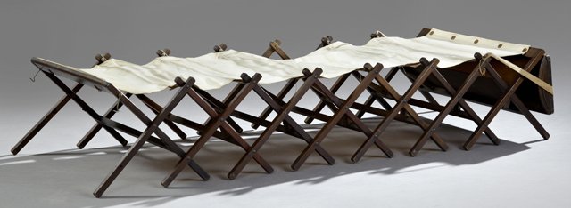 Unusual Oak "Cabinetta" Folding Companion Cot, early: Unusual Oak "Cabinetta" Folding Companion Cot, early 20th c., by Wales, Closed- H.- 22 1/8 in., W.- 31 in., D.- 9 1/8 in., Open- H.- 14 in., W.- 72 in., D.- 30 in.