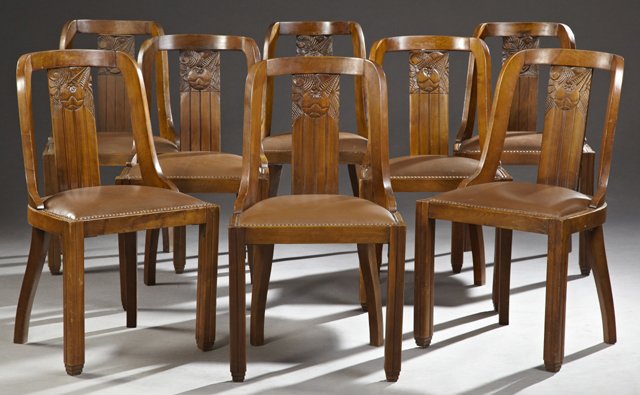 Set of Eight French Art Deco Carved Mahogany Dining: Set of Eight French Art Deco Carved Mahogany Dining Chairs, c. 1930, of gondola form, the curved back with a flower carved vertical splat, to d-shaped seats, on reeded legs to tapered feet, now in bro