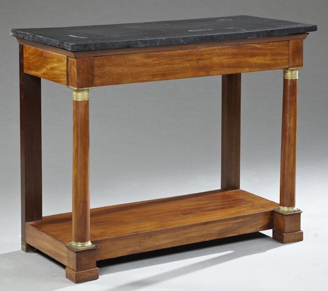 French Empire Ormolu Mounted Carved Mahogany Marble Top: French Empire Ormolu Mounted Carved Mahogany Marble Top Console Table, 19th c., the highly figured black marble over a frieze drawer on ormolu mounted turned tapered columnar legs to stepped square fe