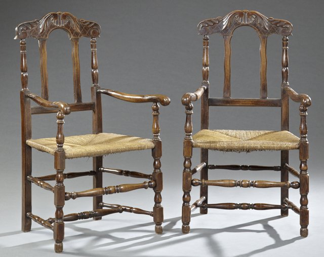 Pair of French Provincial Jacobean Style Carved Beech: Pair of French Provincial Jacobean Style Carved Beech Rush Seat Fauteuils, 19th c., the arched crest rails over a woven rush seat within leaf carved arms on turned tapered legs to turned feet joined b