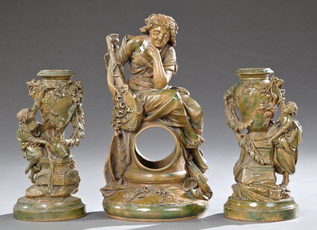 French Three Piece Glazed Terra Cotta Clock Set, 19th: French Three Piece Glazed Terra Cotta Clock Set, 19th c., with a central lute player, and two urn garnitures, with relief maidens filling water jugs, now lacking the clock movement, Clock Case- H.- 19