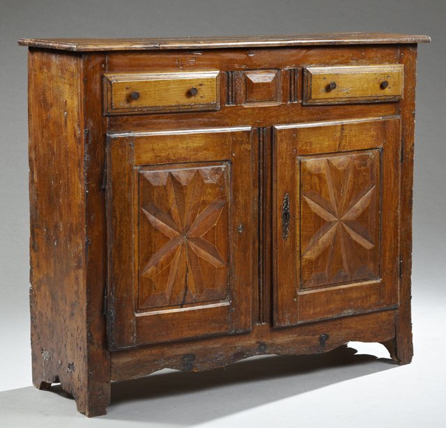 French Louis XIII Style Carved Elm and Cherry: French Louis XIII Style Carved Elm and Cherry Sideboard, 19th c., the rectangular stepped top over two frieze drawers above two fielded panel cupboard doors, on square legs joined by a serpentine skir