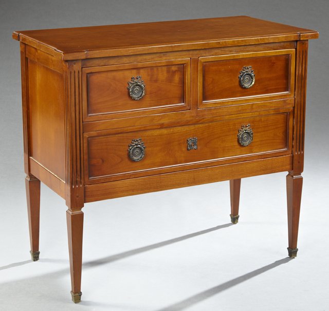 French Louis XVI Style Carved Mahogany Commode, 20th: French Louis XVI Style Carved Mahogany Commode, 20th c., the breakfront top over two drawers above a long drawer, flanked by fluted stiles, on square tapered legs with ormolu sabots, branded "Claude M