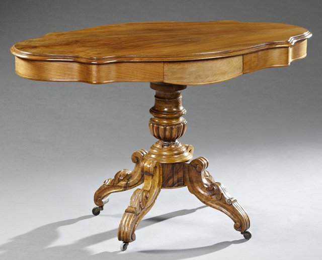 French Louis Philippe Carved Walnut Turtle Top Center: French Louis Philippe Carved Walnut Turtle Top Center Table, 19th c., the stepped edge top over a wide skirt with two opposing frieze drawers on a baluster turned support to acanthus carved S-scroll q