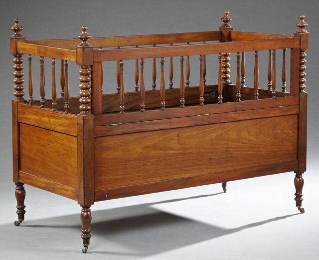 French Carved Walnut Youth Crib, 19th c., the corners: French Carved Walnut Youth Crib, 19th c., the corners with bobbin turned supports, joined by spindled sides, one side hinged to drop for easy access, on ring turned tapered legs on French toes, H.- 43