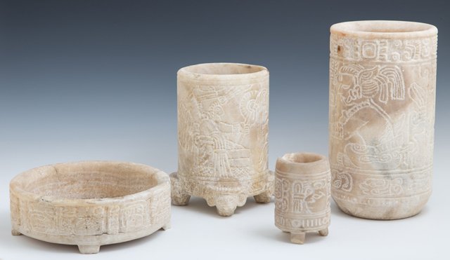 Four Pre-Columbian Mayan Carved Alabaster Pieces,: Four Pre-Columbian Mayan Carved Alabaster Pieces, consisting of three cylindrical vases and a cylindrical bowl, each with incised figural decoration, Honduras, Largest- H.- 10 in., Dia.- 5 3/4 in. (4
