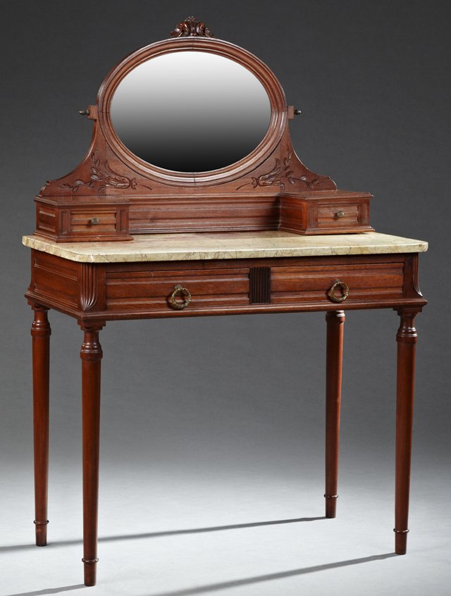 French Louis XVI Style Carved Mahogany Marble Top: French Louis XVI Style Carved Mahogany Marble Top Dressing Table, 20th c., the tilting oval mirror above two glove boxes on highly figured ocher marble, above two frieze drawers, on ring turned tapere